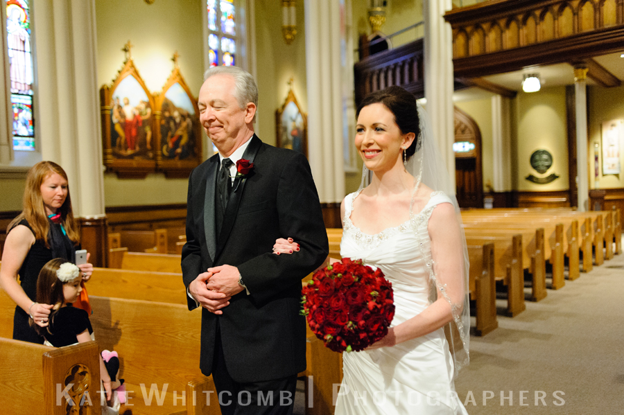 father walking bride down basilica of sacred heart's aisle