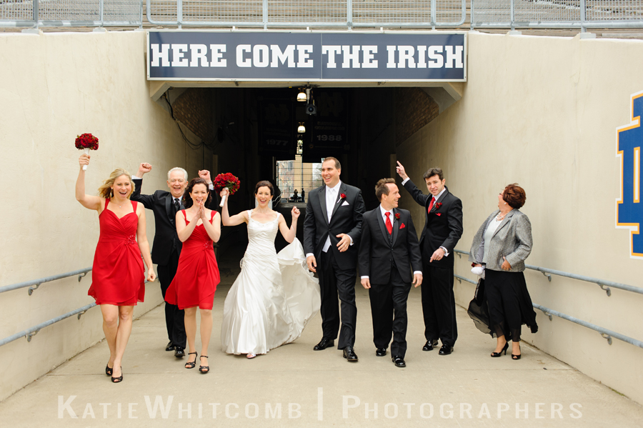 bridal party heading out onto the notre dame football field 