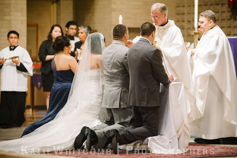 bride and groom receiving holy communion during traditional hispanic catholic ceremony