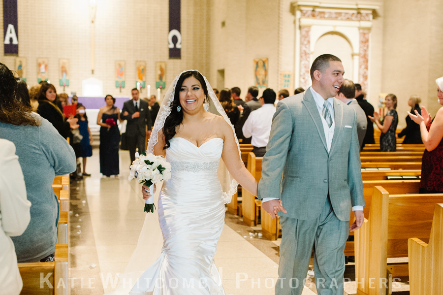 happy couple walking down the aisle as husband and wife