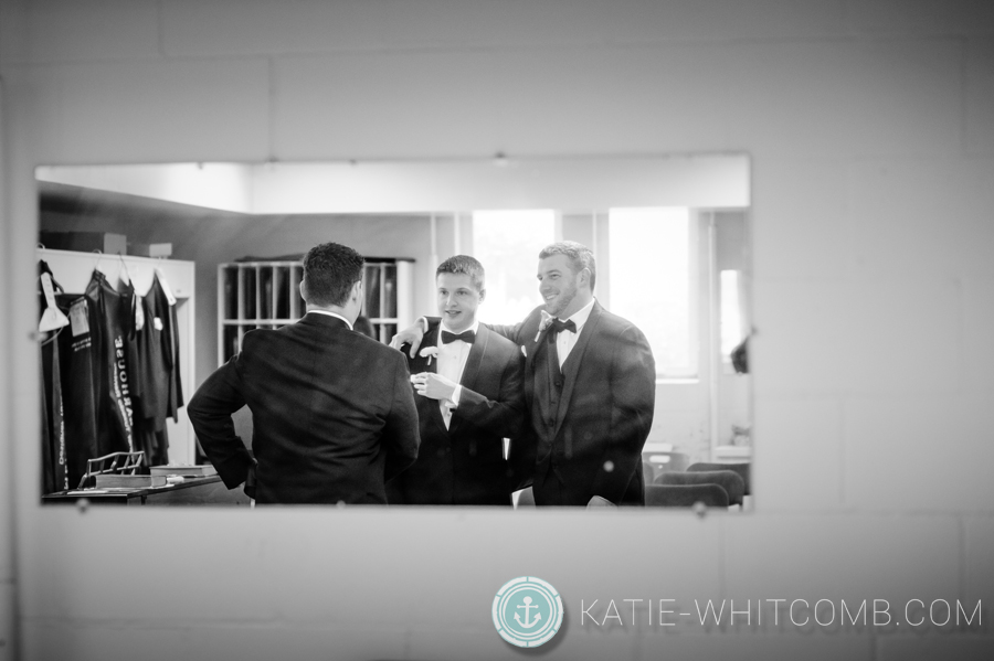 groomsmen getting the groom ready for his bride