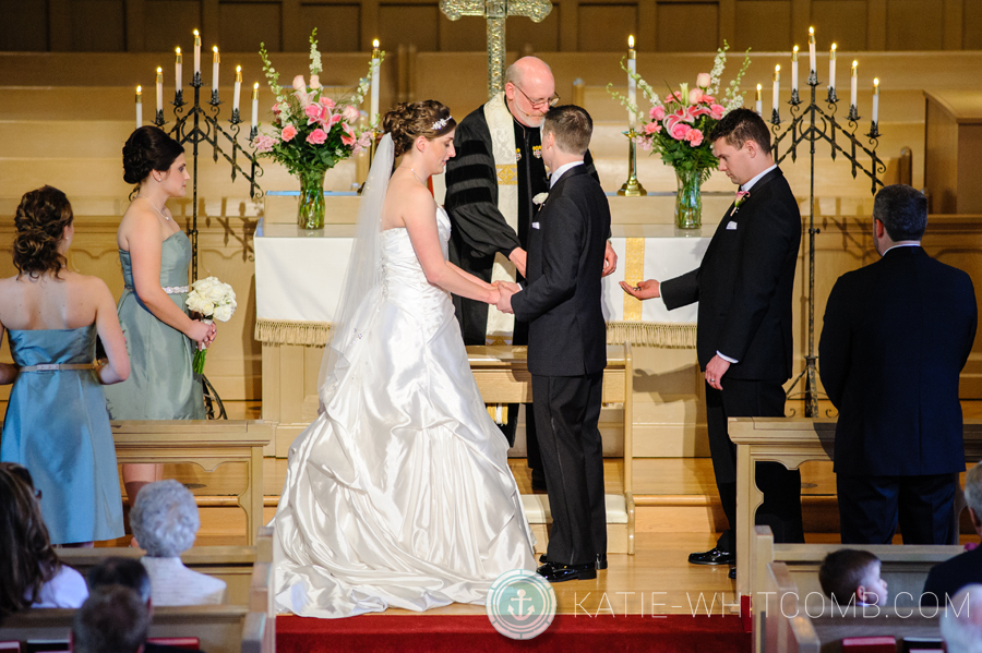 pastor blessing the rings during the ceremony at grace united methodist church