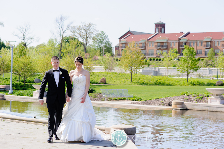 bride and groom walking around at the mishawaka riverwalk