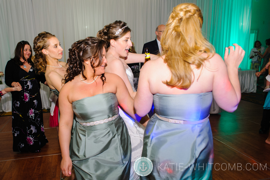 bridesmaids dance with the bride at her wedding reception at doubletree by hilton