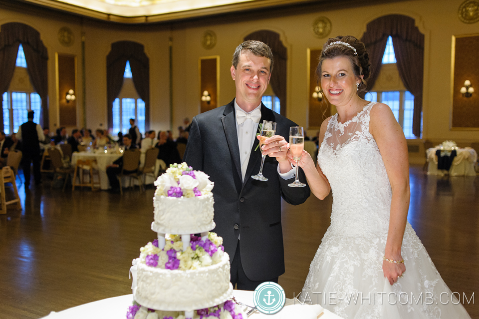 bride & groom cutting their cake at their wedding reception at palais royale