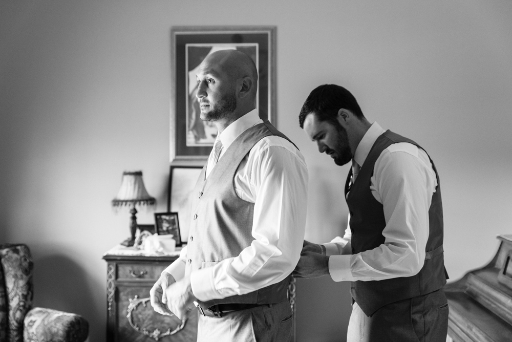 black and white groom getting ready dressed