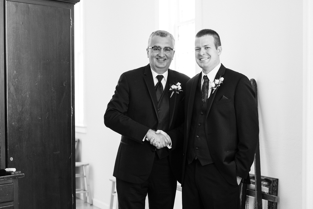 father of the bride shaking hands with groom black and white