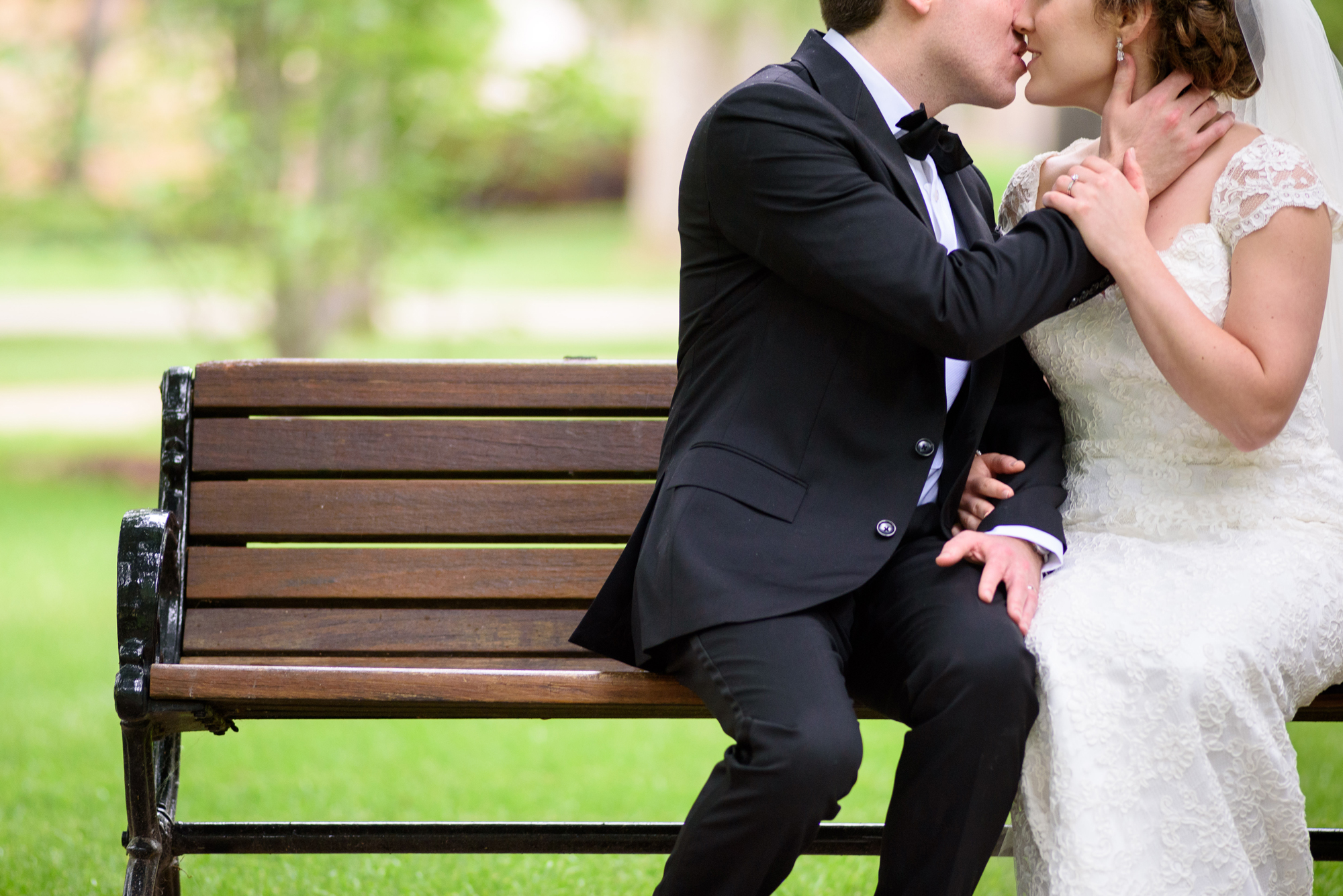 Wedding Couple sitting on a bench in God Quad on the campus of the University of Notre Dame