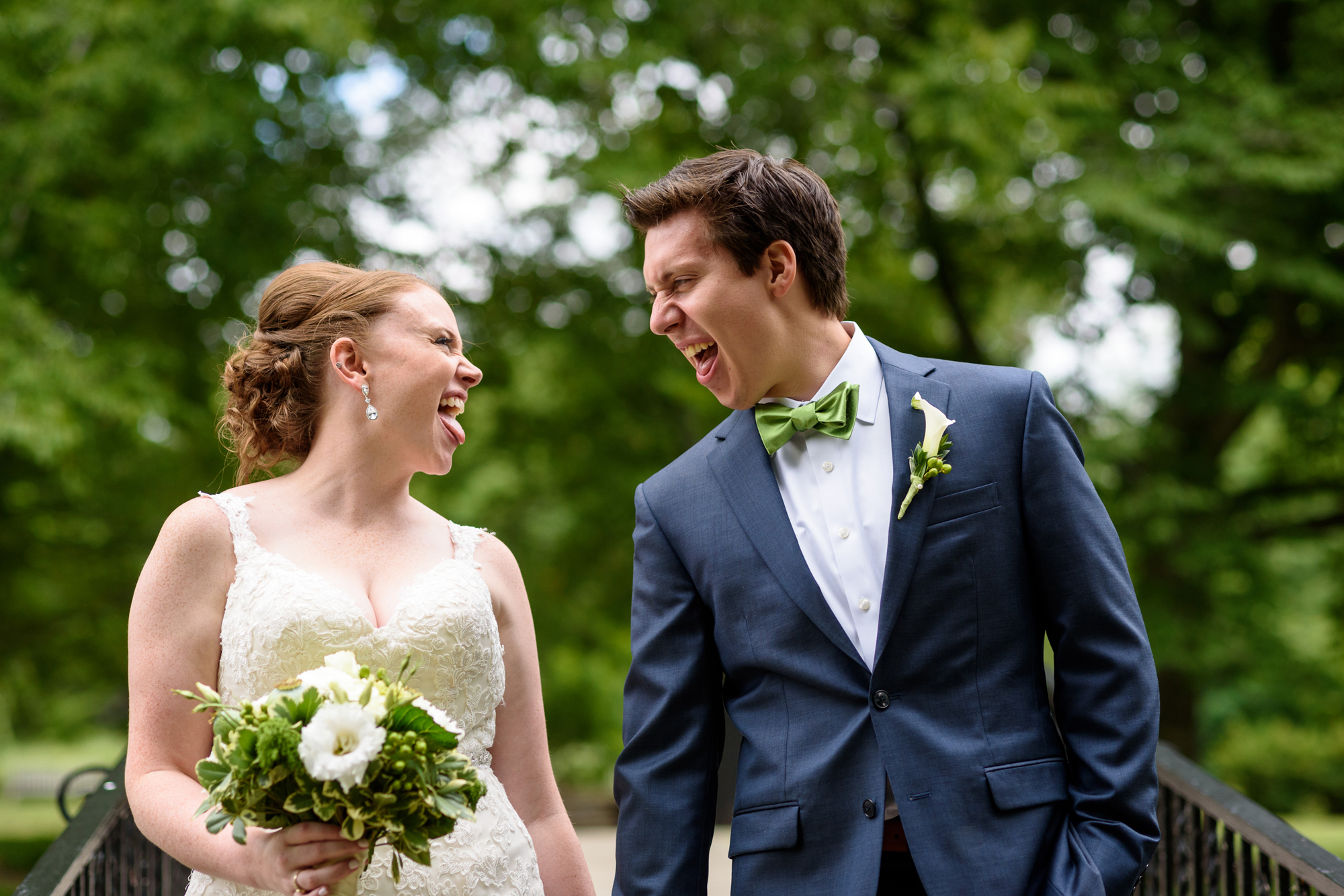 Wedding Couple on the campus of St. Mary's crossing the bridge over the lake