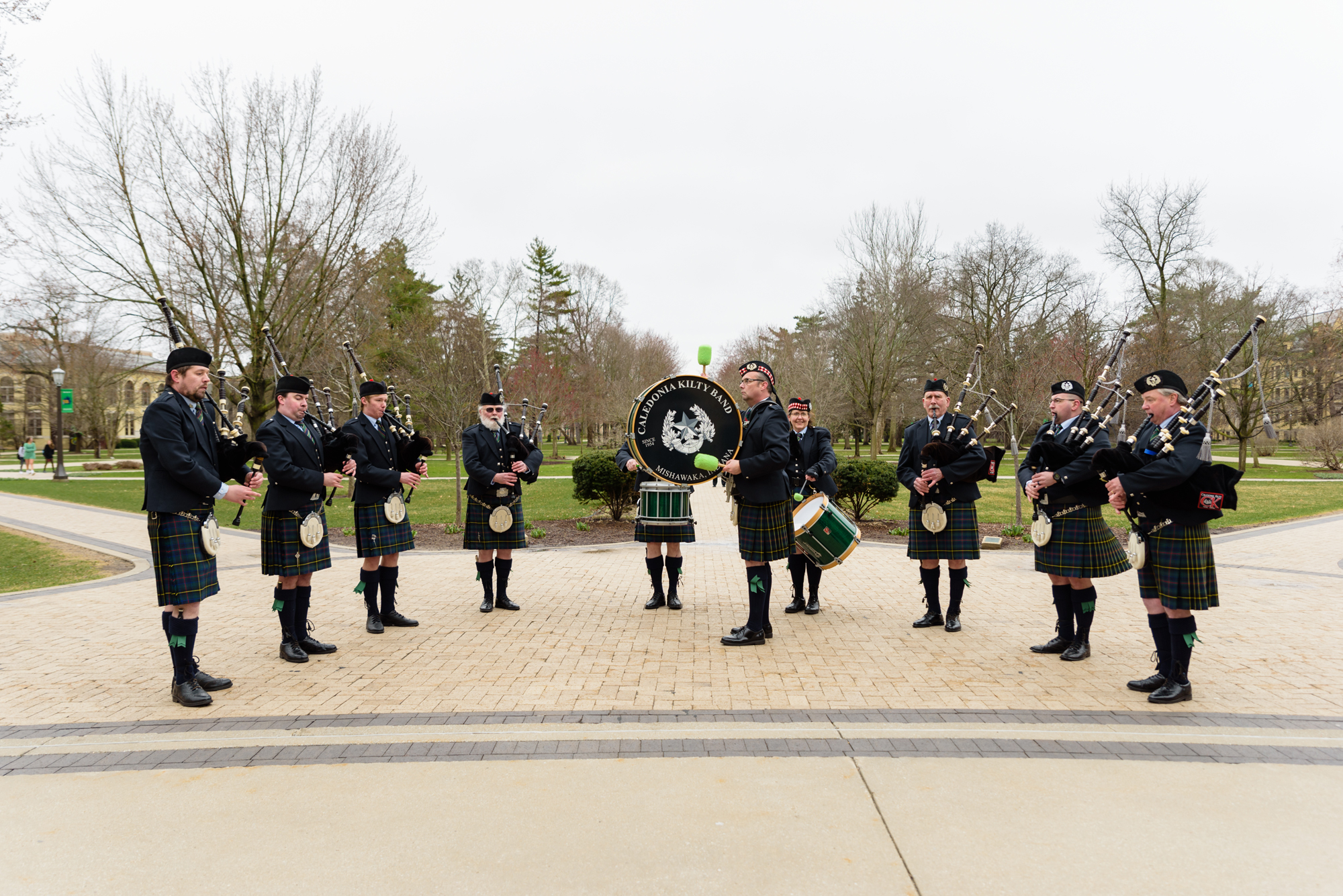 Caledonia Kilty Band bag piper band playing for wedding guests on the campus of University of Notre Dame