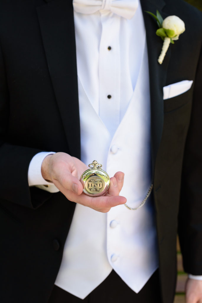 Groom holding heirloom pocket watch