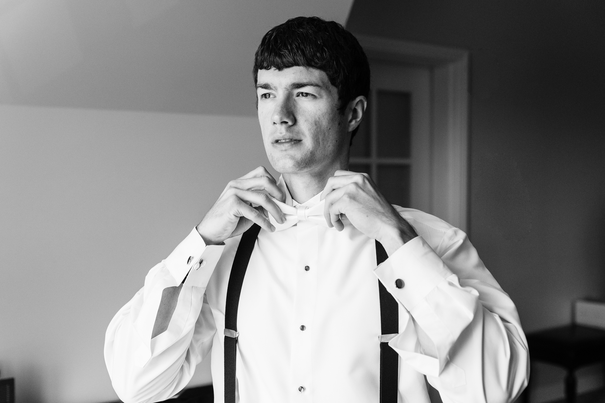 Groom getting ready in his suite at the Morris Inn before his ceremony at the Basilica of the Sacred Heart on the campus of Notre Dame