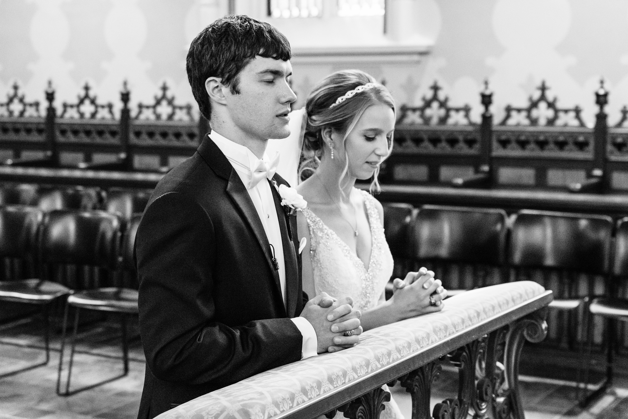 Bride & Groom praying to Mary during their wedding ceremony at the Basilica of the Sacred Heart on the campus of Notre Dame