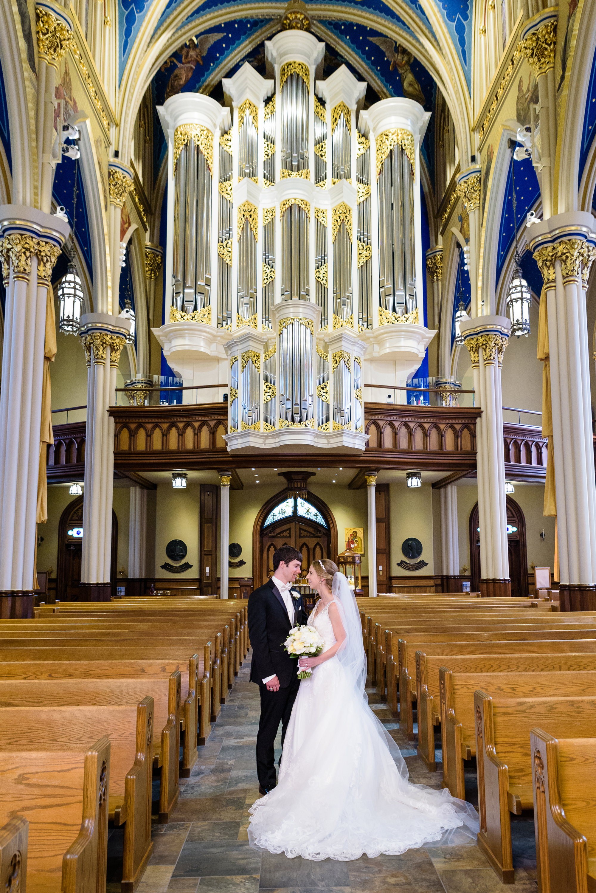 Bride & Groom portrait with the organ after their wedding ceremony at the Basilica of the Sacred Heart on the campus of Notre Dame