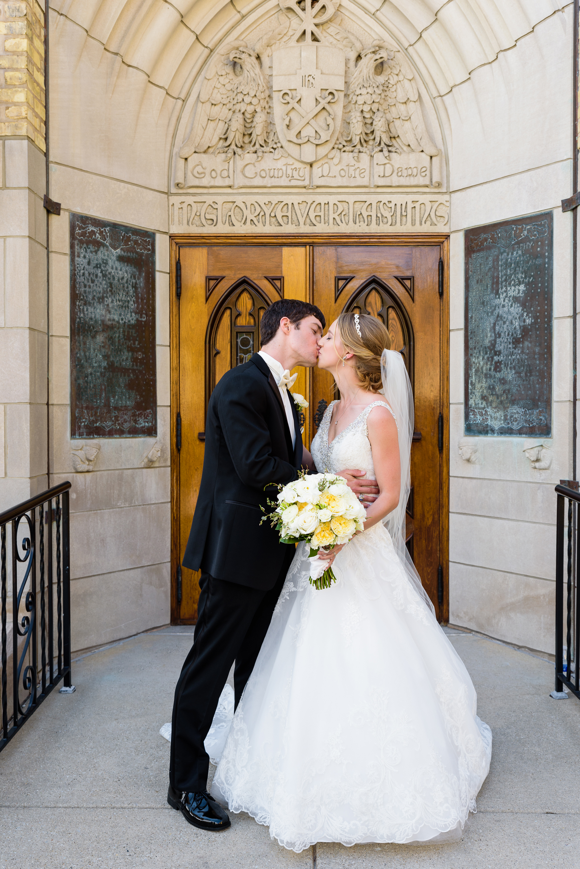 Bride & Groom share a kiss outside the God Country Doo at the Basilica of the Sacred Heart on the campus of Notre Dame