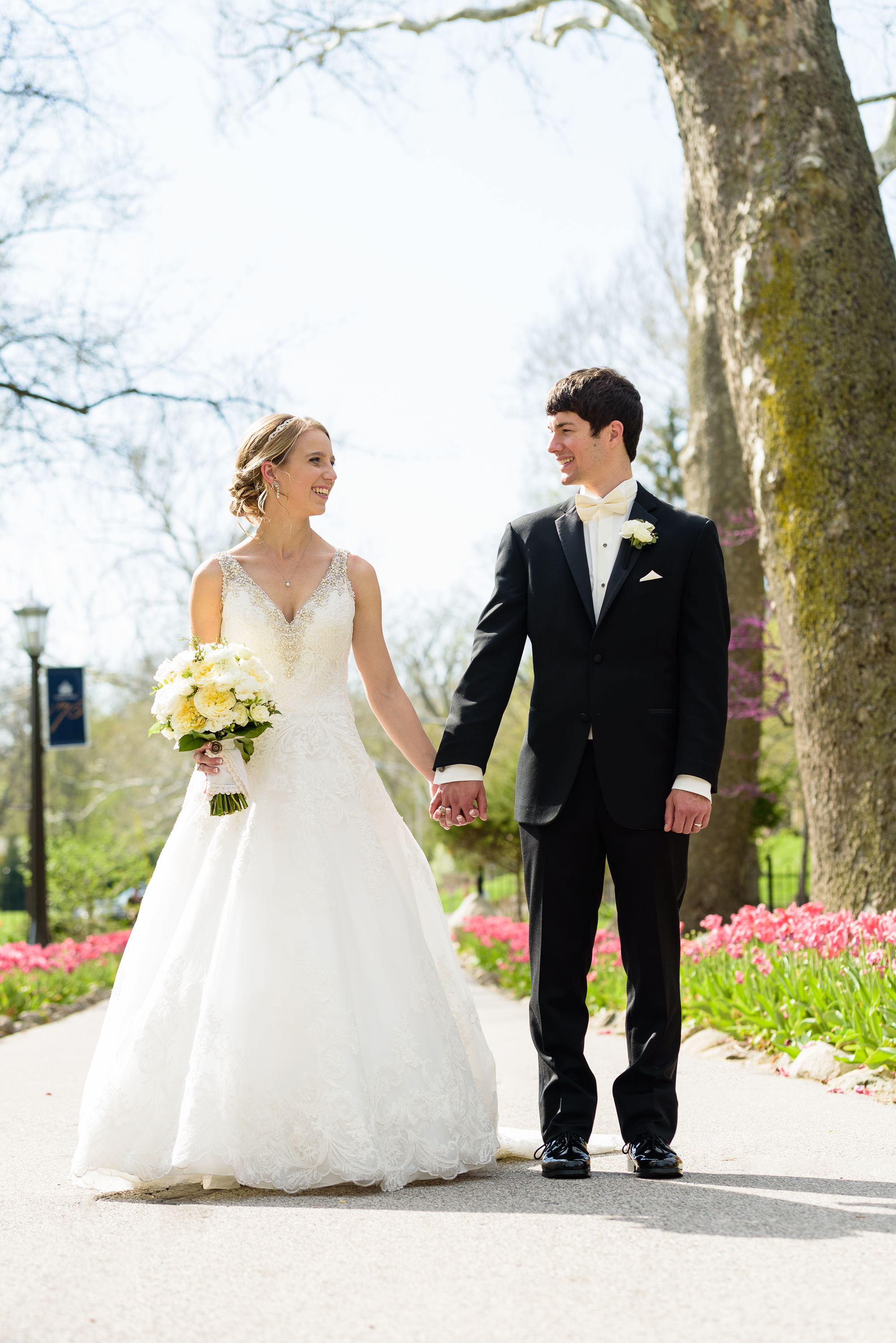 Bride & Groom by the tulips at the Grotto on the campus of Notre Dame