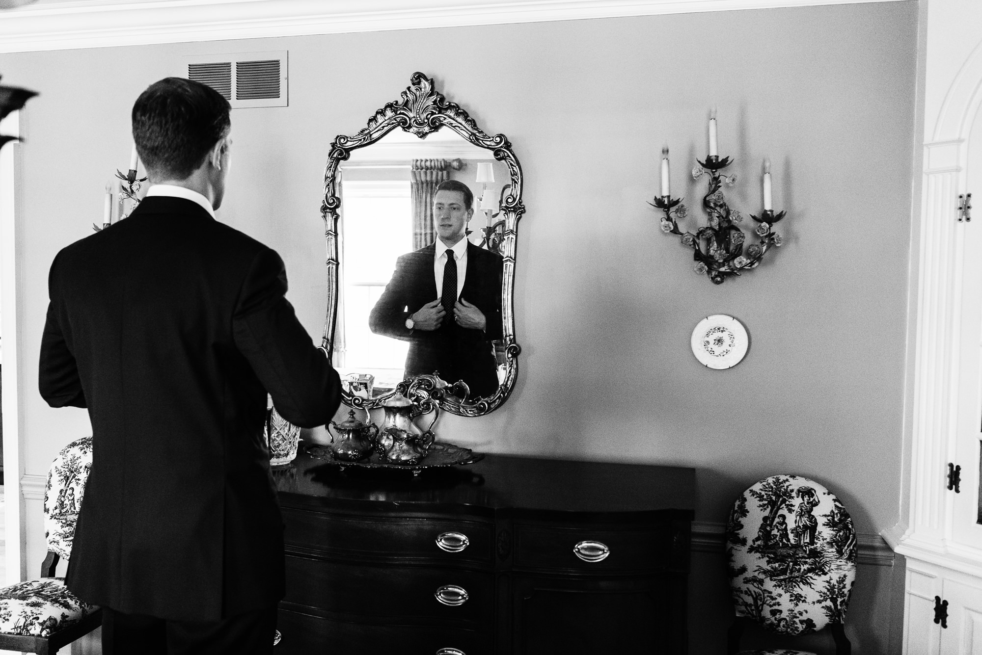 Groom getting ready before his wedding ceremony at the Basilica of the Sacred Heart on the campus of the University of Notre Dame