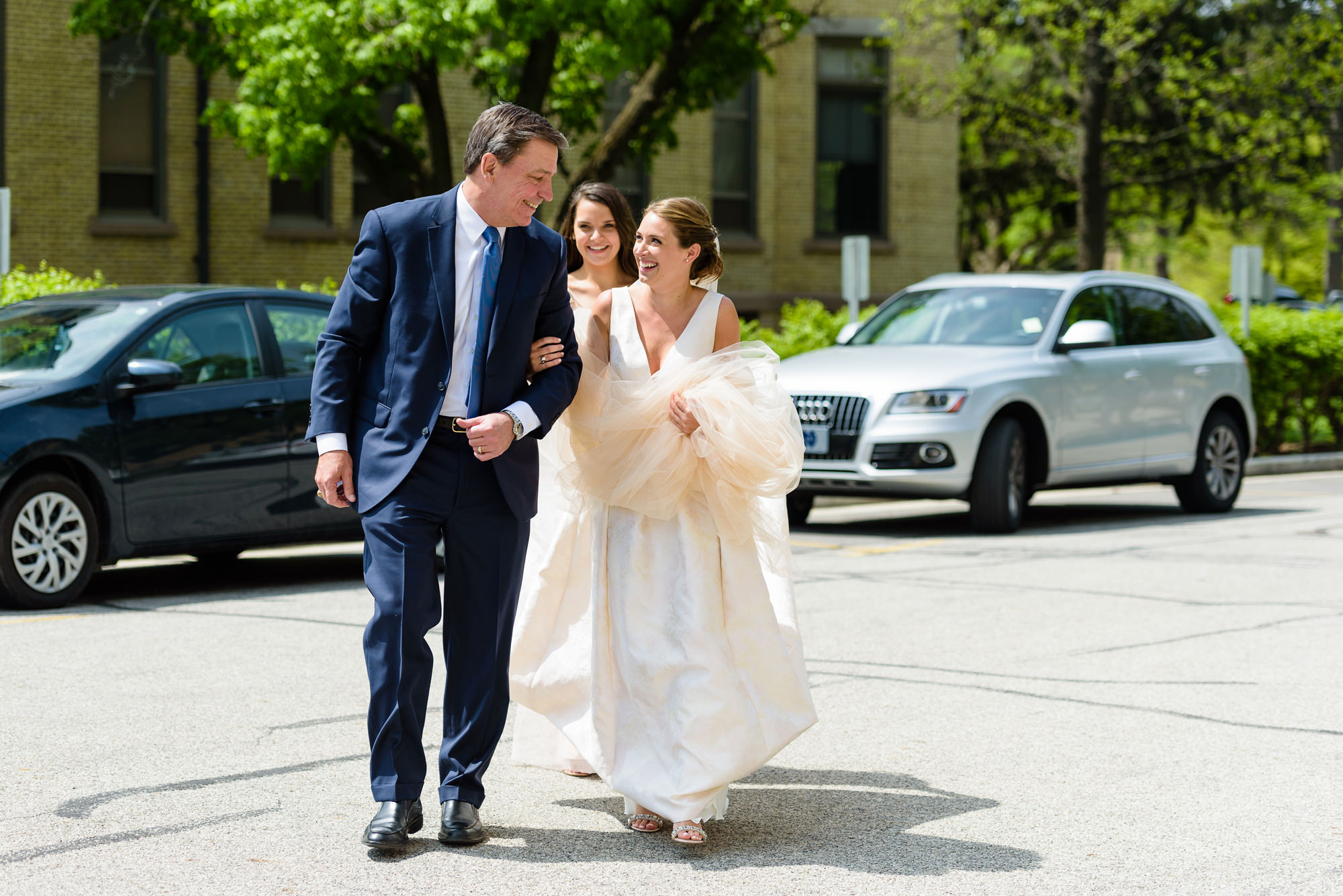 Bride walking up to the church with her father before her wedding ceremony at the Basilica of the Sacred Heart on the campus of the University of Notre Dame