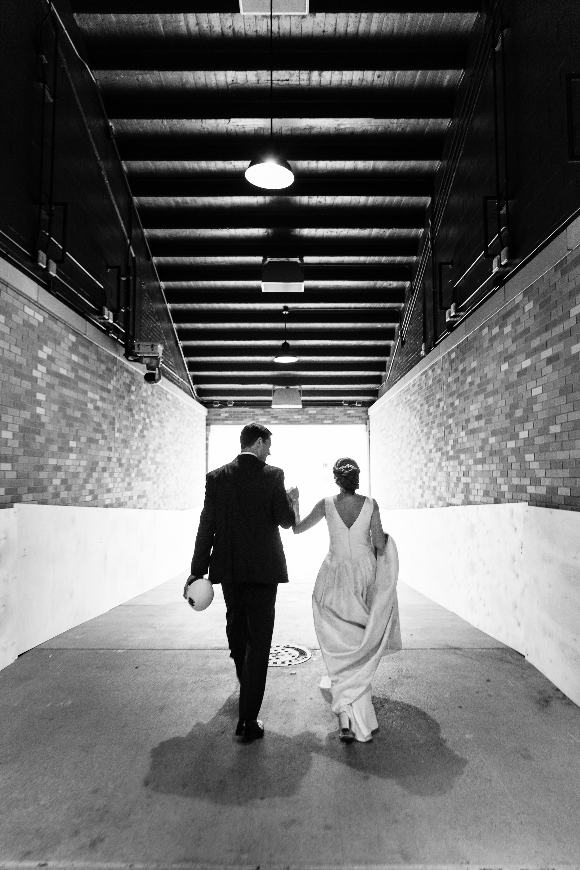 Bride & Groom walking down the tunnel to the Notre Dame football stadium