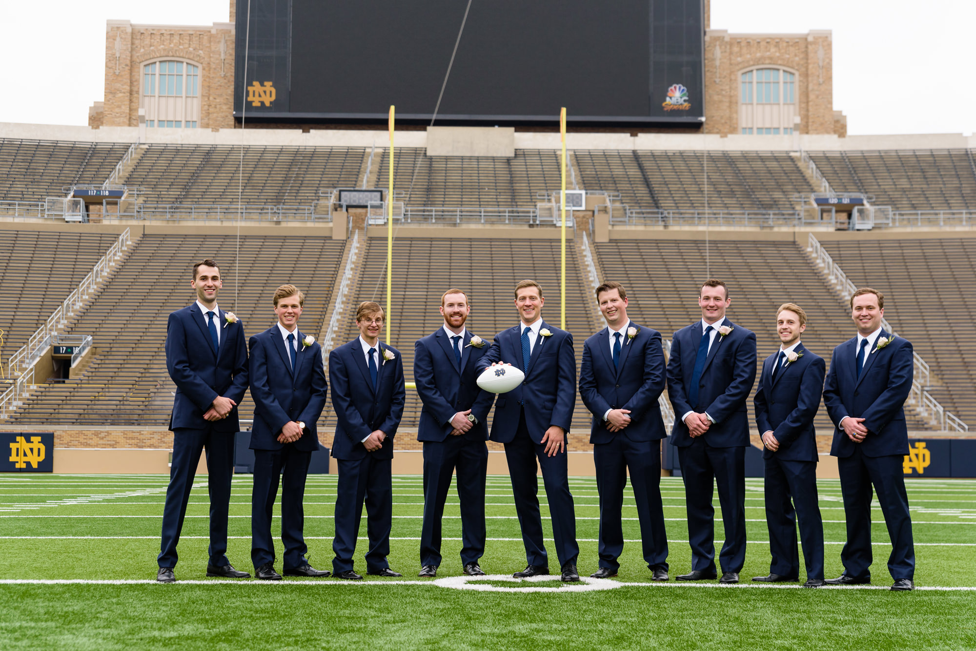 Groomsmen on the field of Notre Dame football stadium