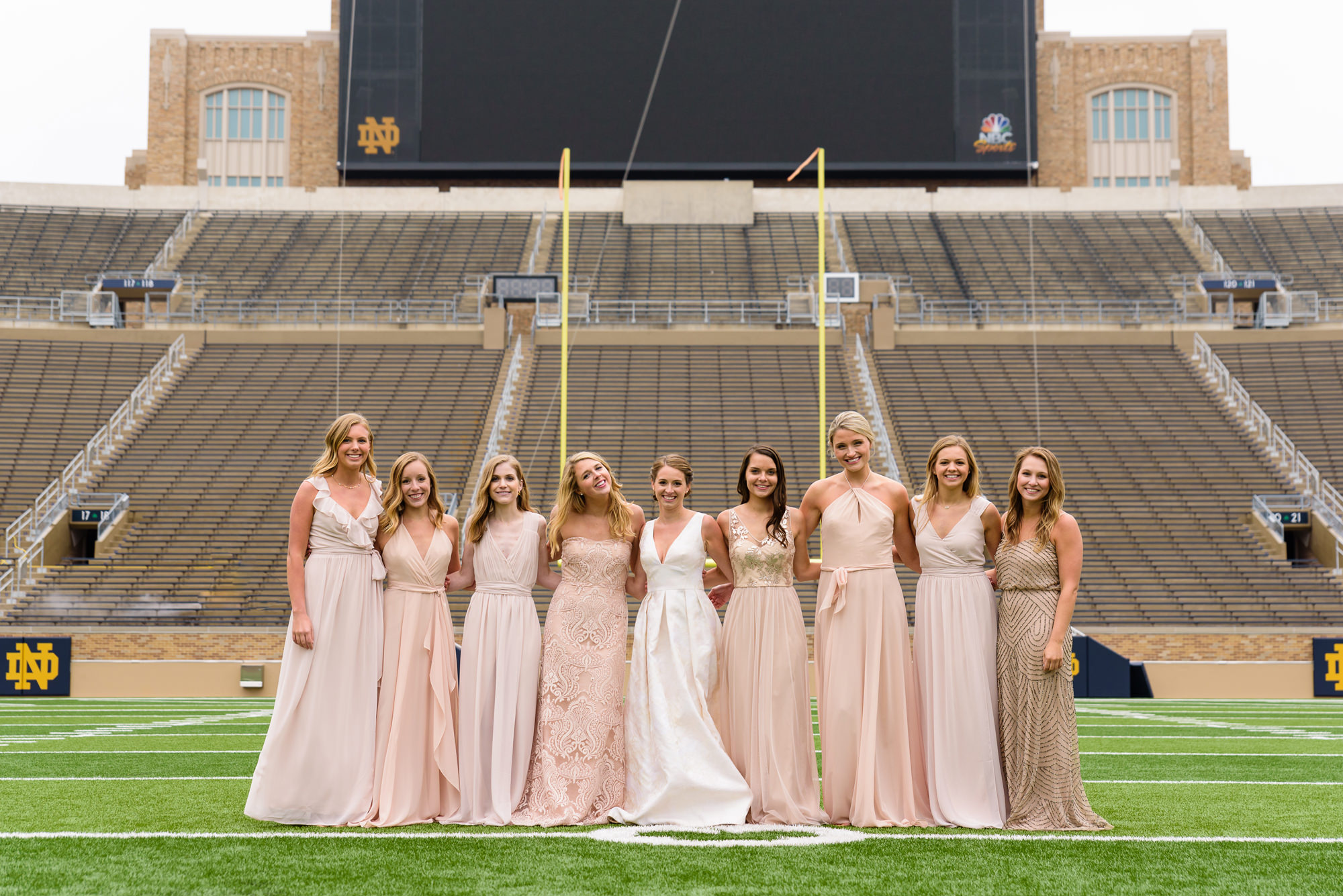 Bridesmaids on the field of Notre Dame football stadium