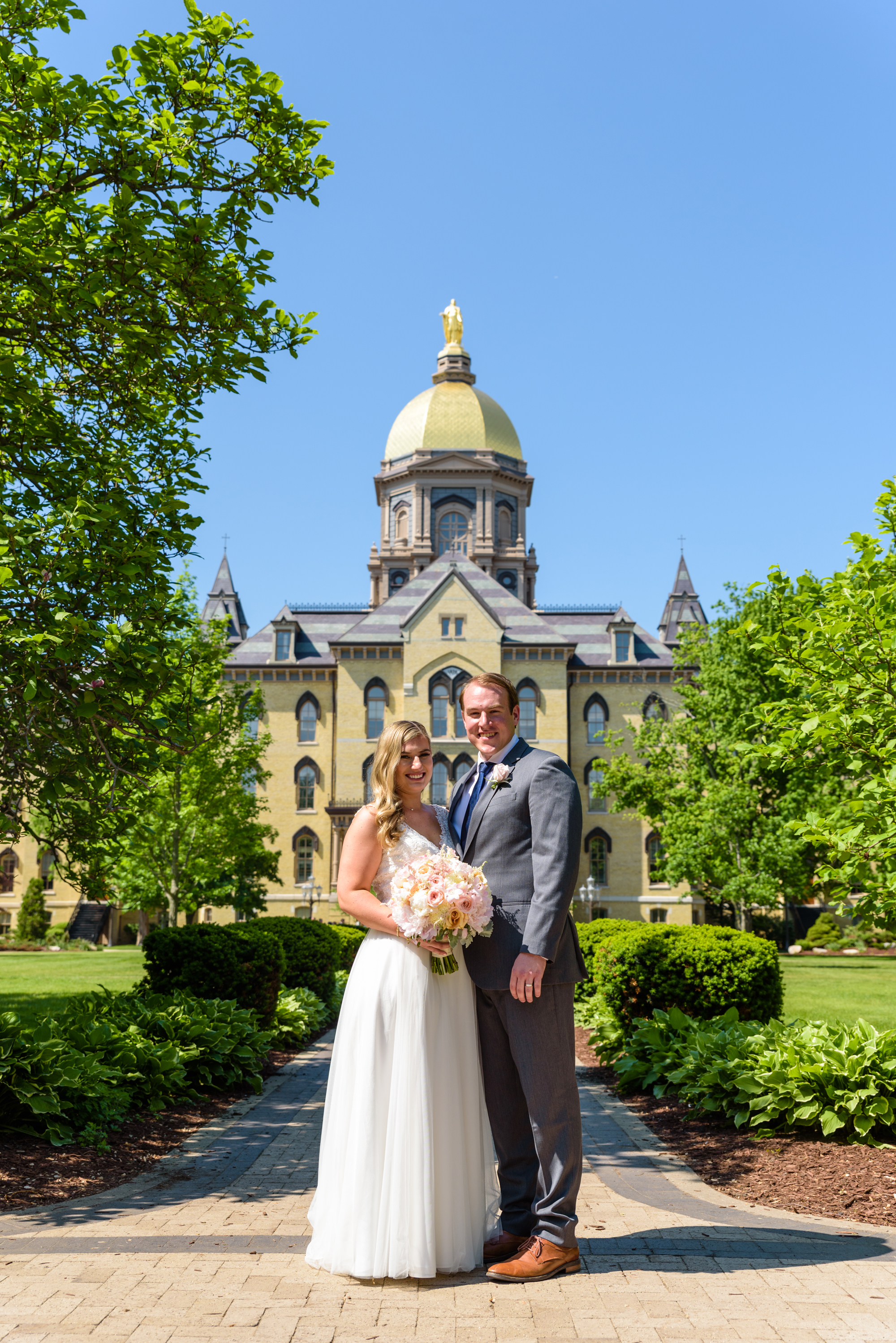 Bride & Groom in front of the Golden Dome after their ceremony at the Basilica of the Sacred Heart on the campus of Notre Dame
