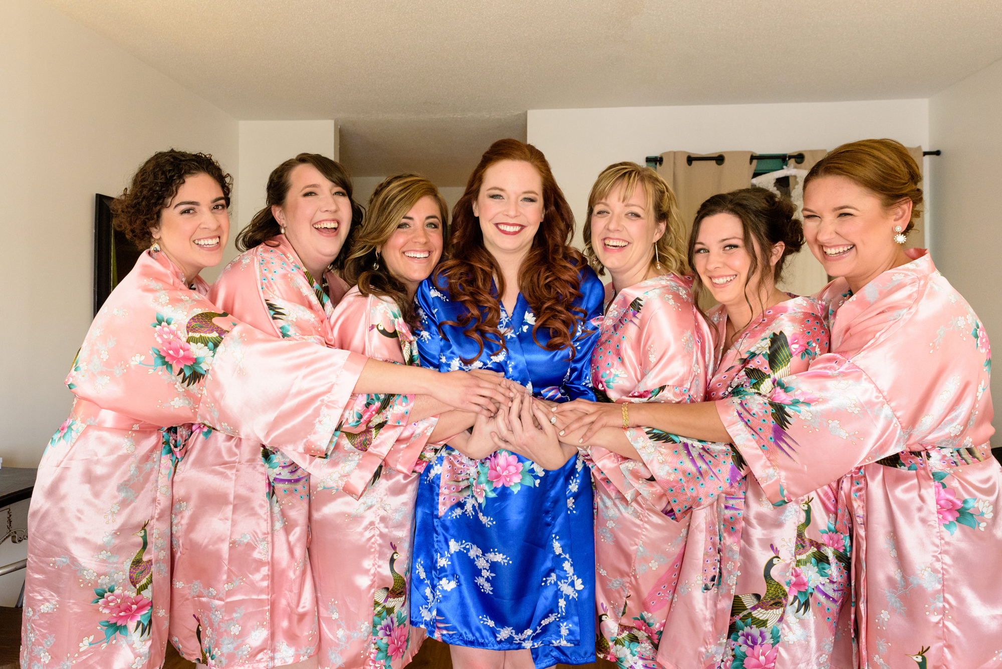 Bride with her Bridesmaids in their silk, floral robes before her wedding at Amish Acres
