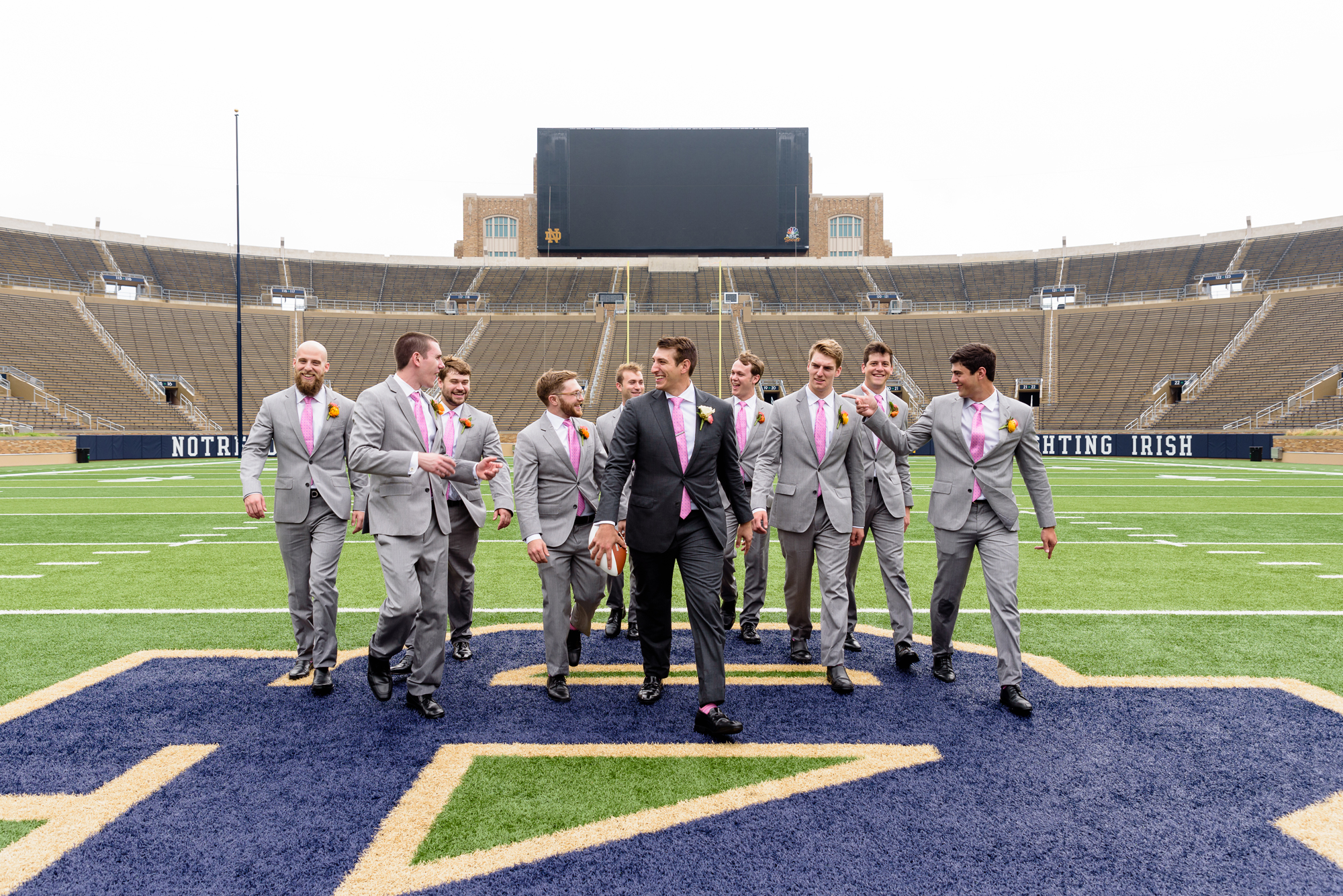 Groomsmen on the field in the stadium after their wedding ceremony at the Basilica of the Sacred Heart on the campus of University of Notre Dame