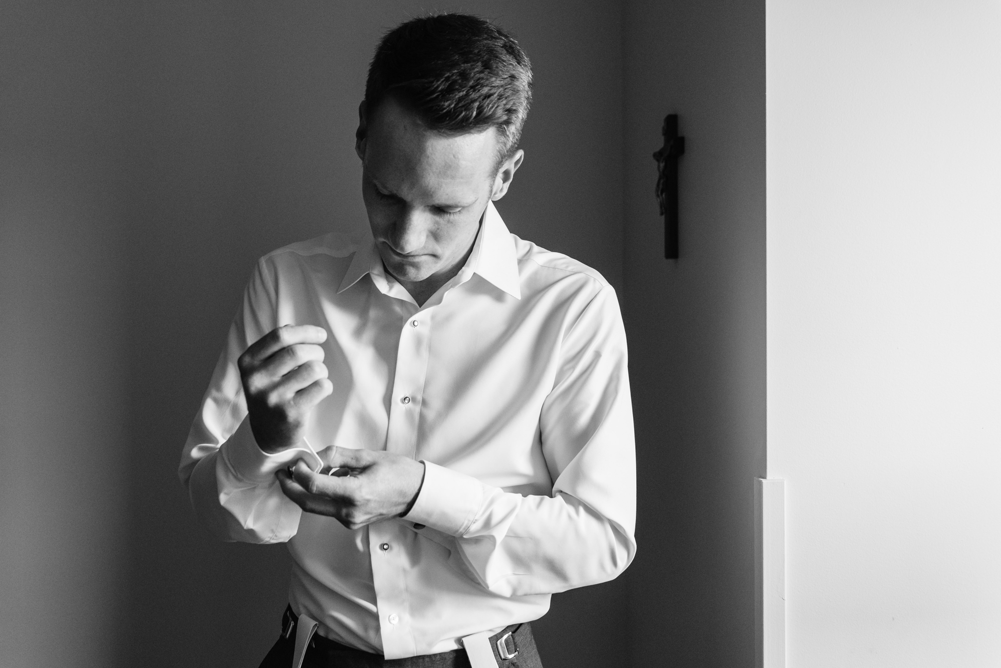 Groom getting ready before his wedding ceremony at the Basilica of the Sacred Heart on the campus of the University of Notre Dame