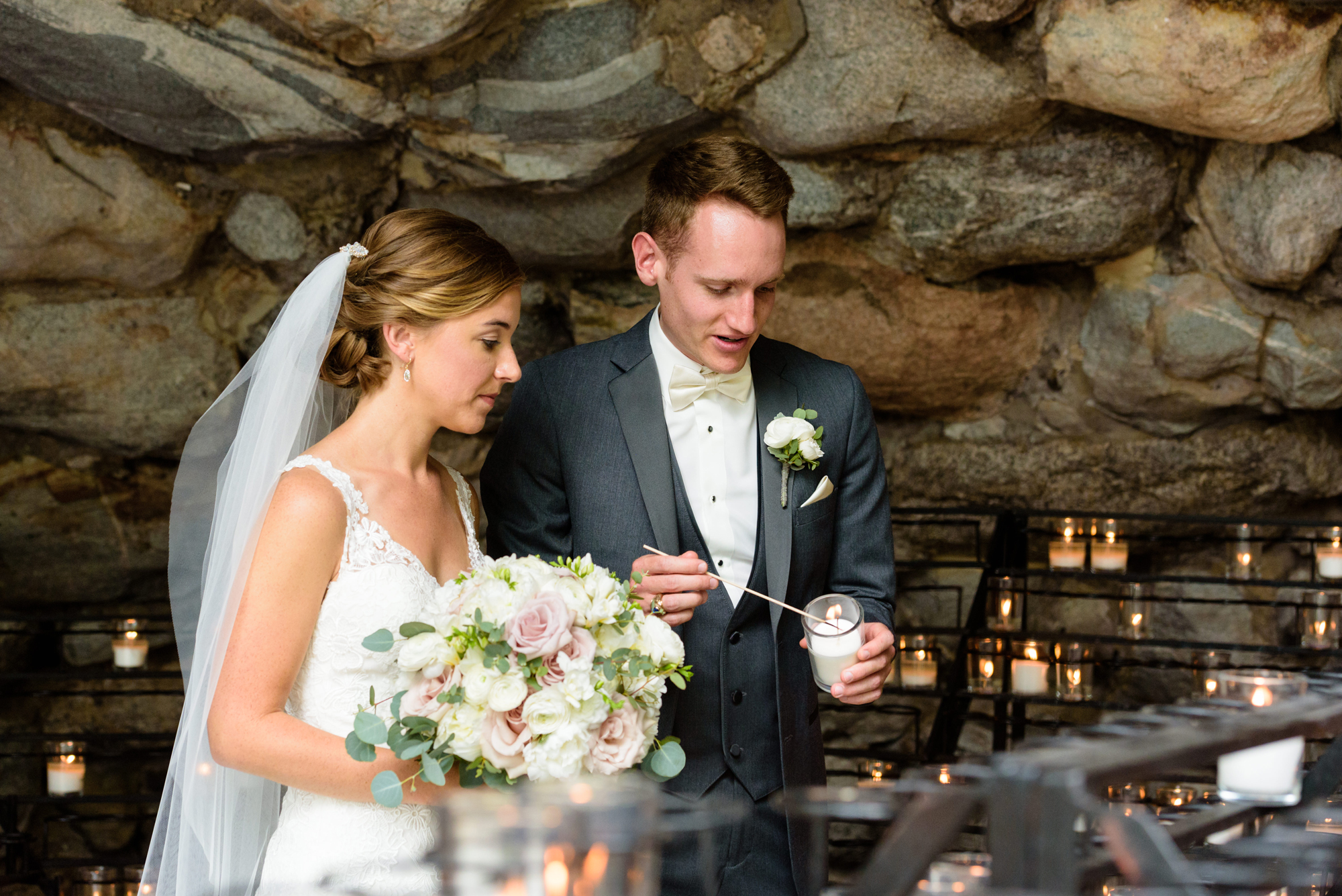 Bride & Groom lighting a candle at the Grotto before their wedding ceremony at the Basilica of the Sacred Heart on the campus of the University of Notre Dame