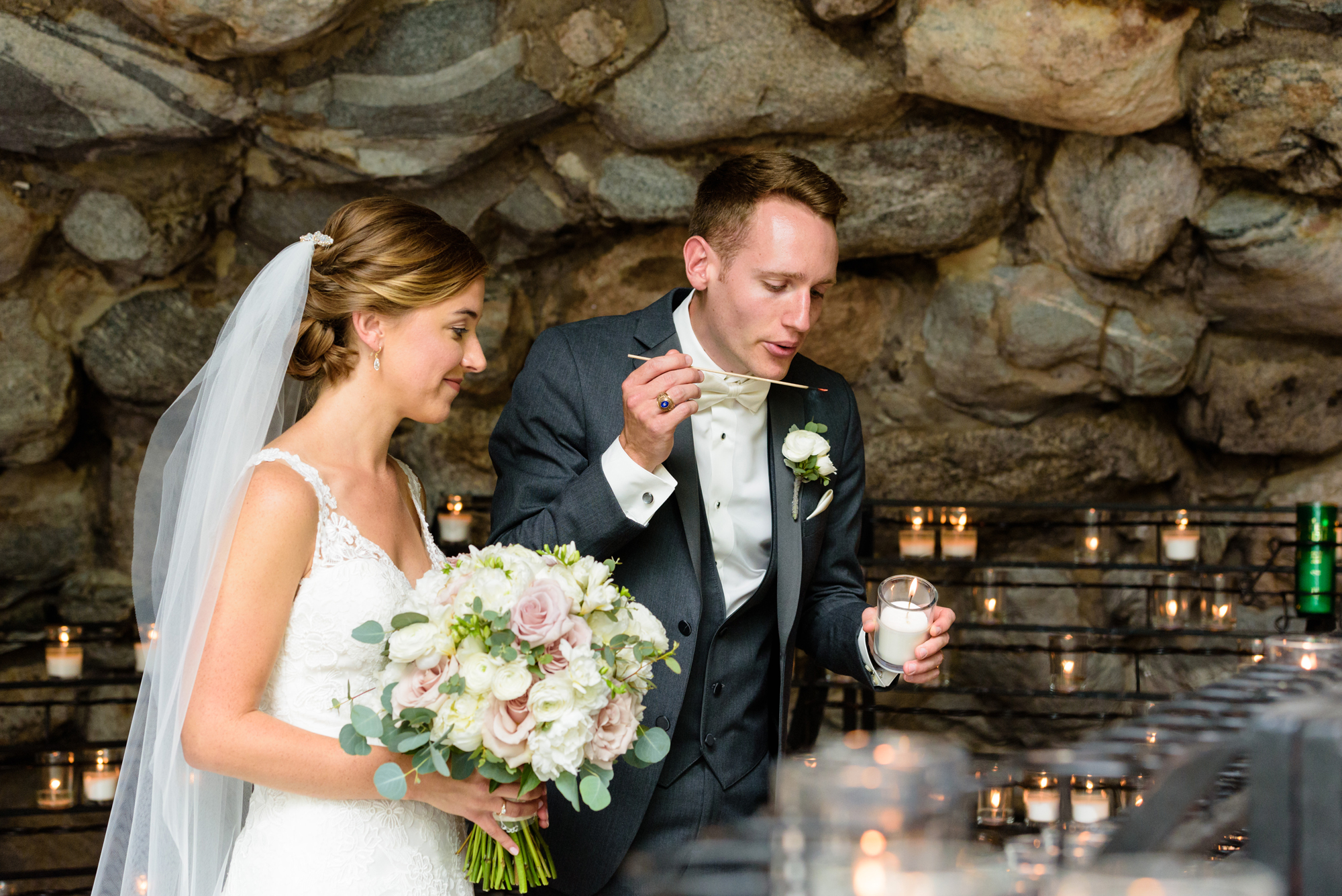 Bride & Groom lighting a candle at the Grotto before their wedding ceremony at the Basilica of the Sacred Heart on the campus of the University of Notre Dame