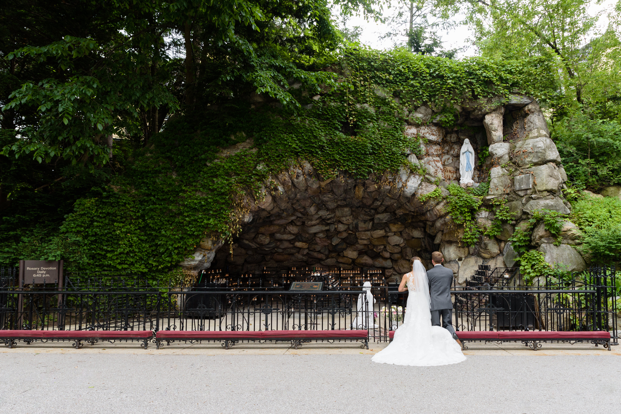 Bride & Groom lighting a candle at the Grotto before their wedding ceremony at the Basilica of the Sacred Heart on the campus of the University of Notre Dame