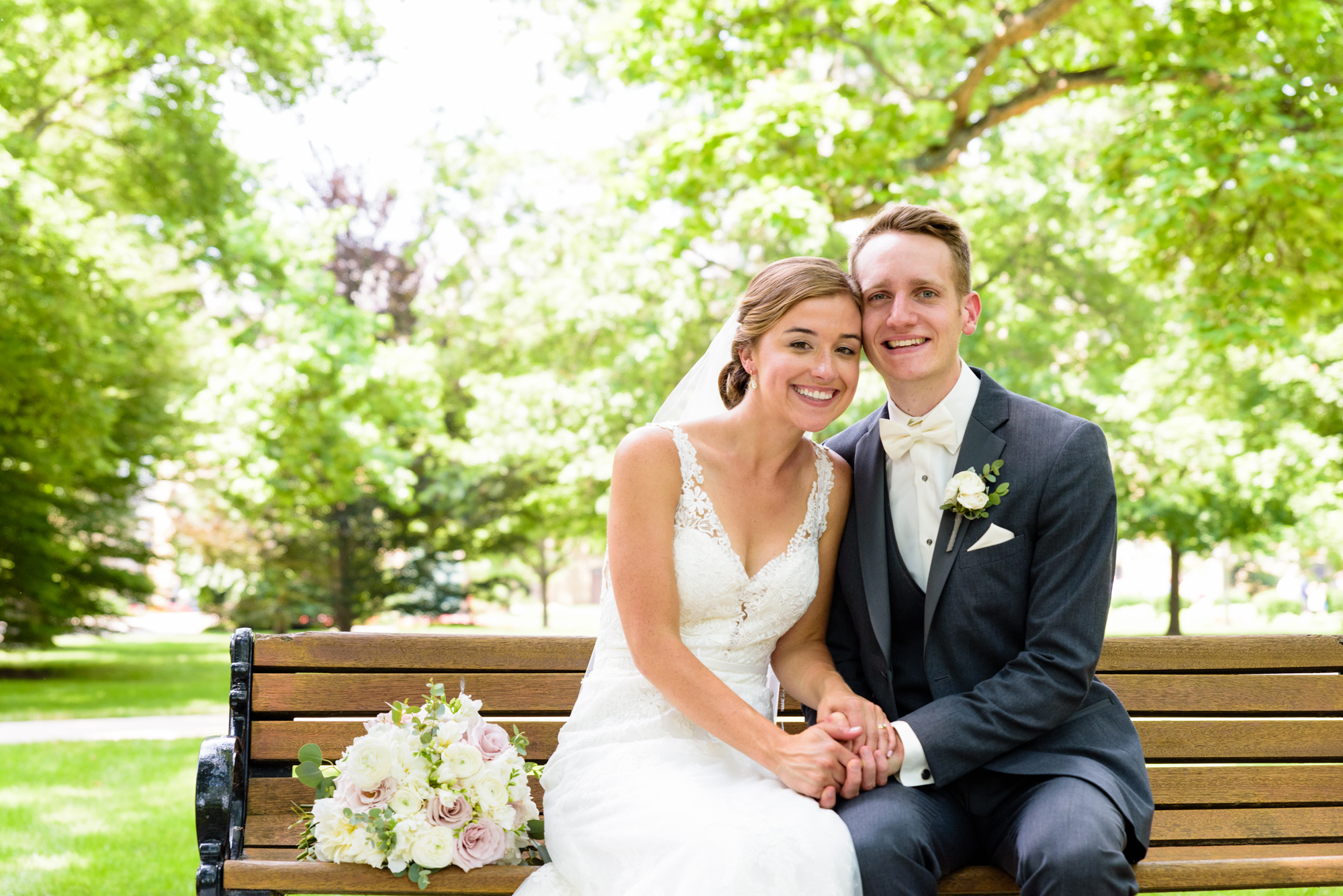 Bride & Groom at a bench on God Quad on the campus of the University of Notre Dame