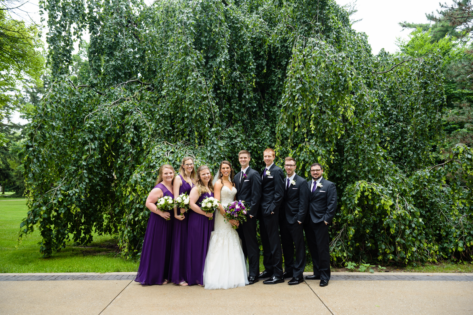 Bridal Party in front of an exotic California inspired tree after a wedding ceremony at the Basilica of the Sacred Heart on the campus of the University of Notre Dame