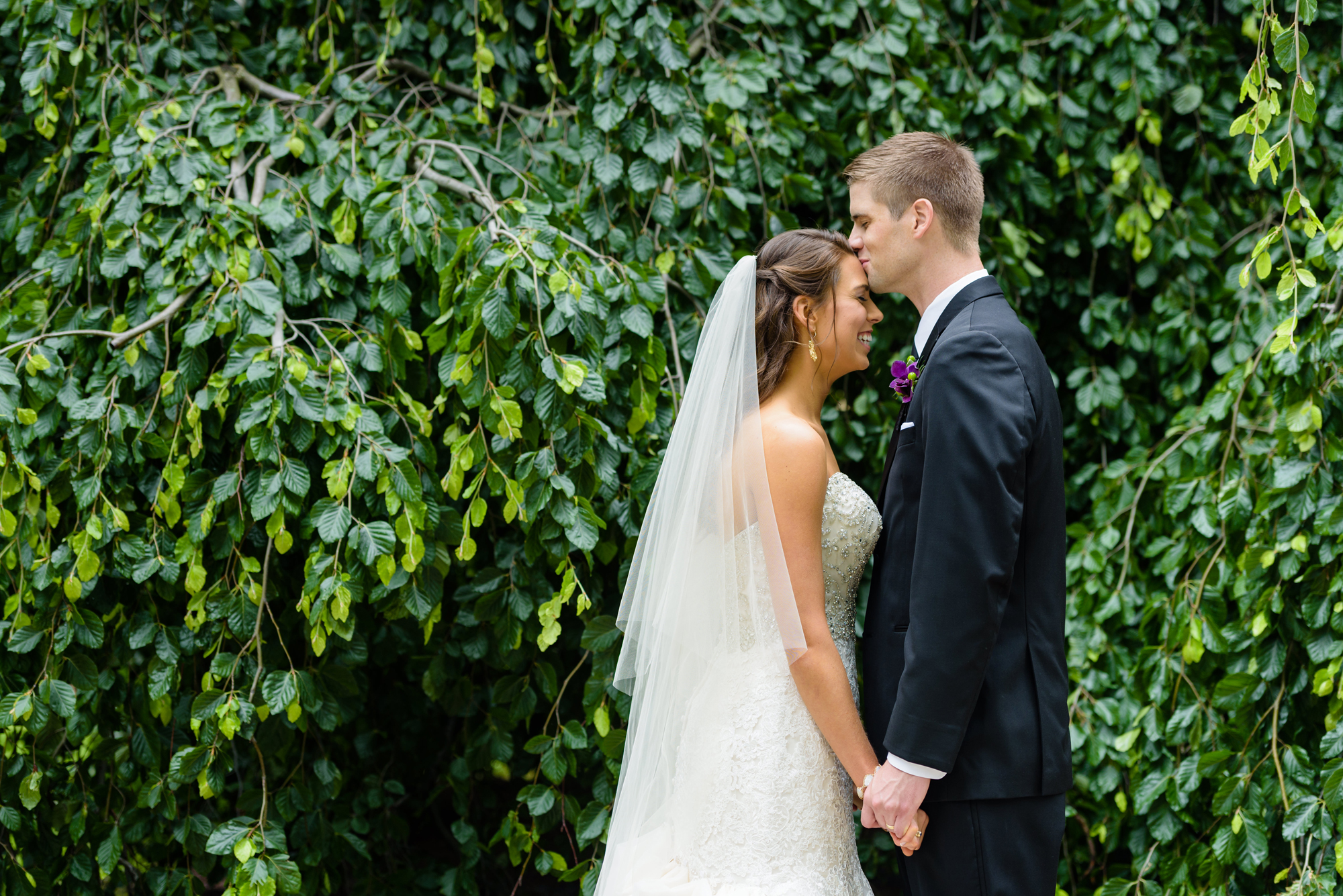 Bride & Groom in front of an exotic California inspired tree after their wedding ceremony at the Basilica of the Sacred Heart on the campus of the University of Notre Dame