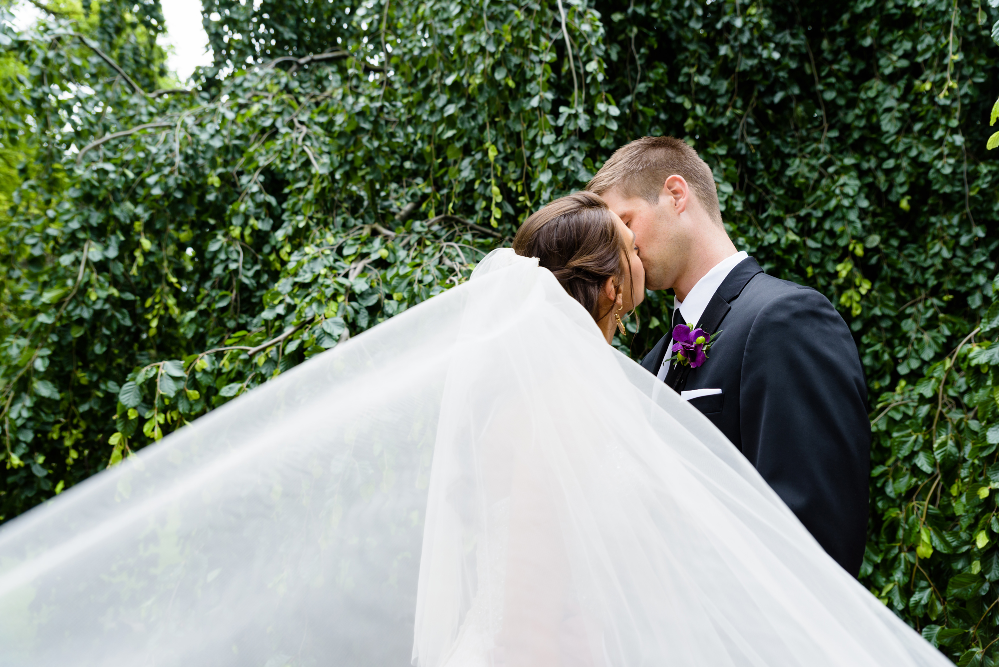 Bride & Groom in front of an exotic California inspired tree after their wedding ceremony at the Basilica of the Sacred Heart on the campus of the University of Notre Dame