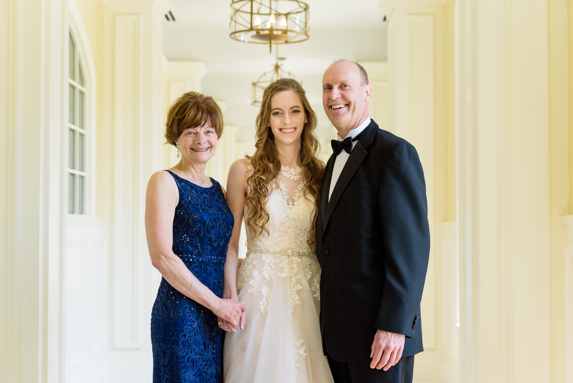 Bride with her mother and father before a wedding ceremony at the Basilica of the Sacred Heart on the campus of the University of Notre Dame