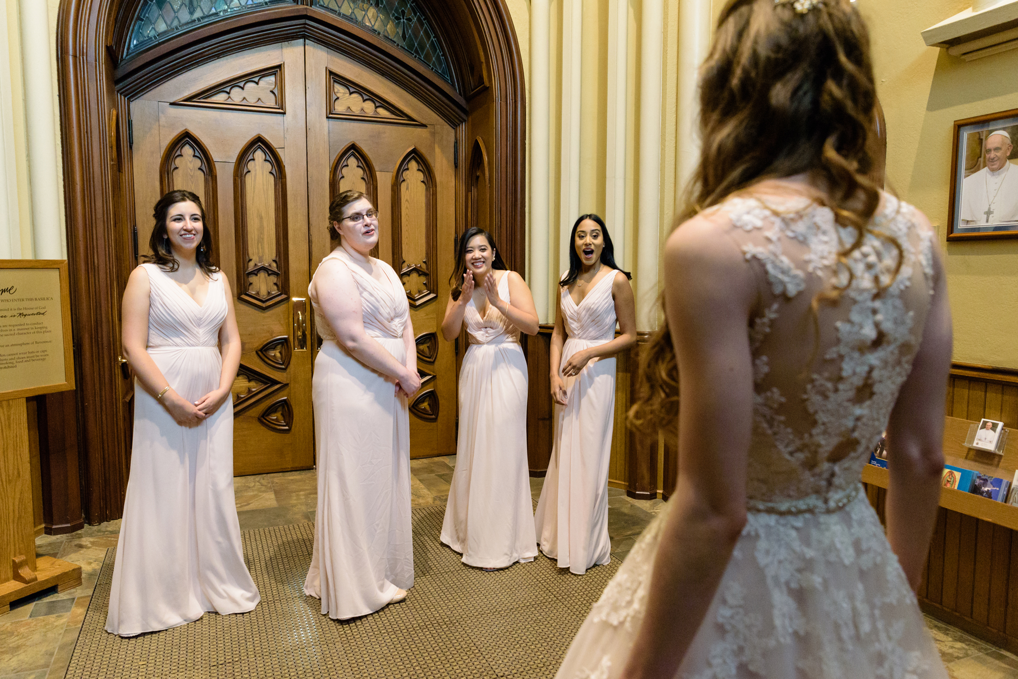 Bridesmaid reveal before a wedding ceremony at the Basilica of the Sacred Heart on the campus of the University of Notre Dame