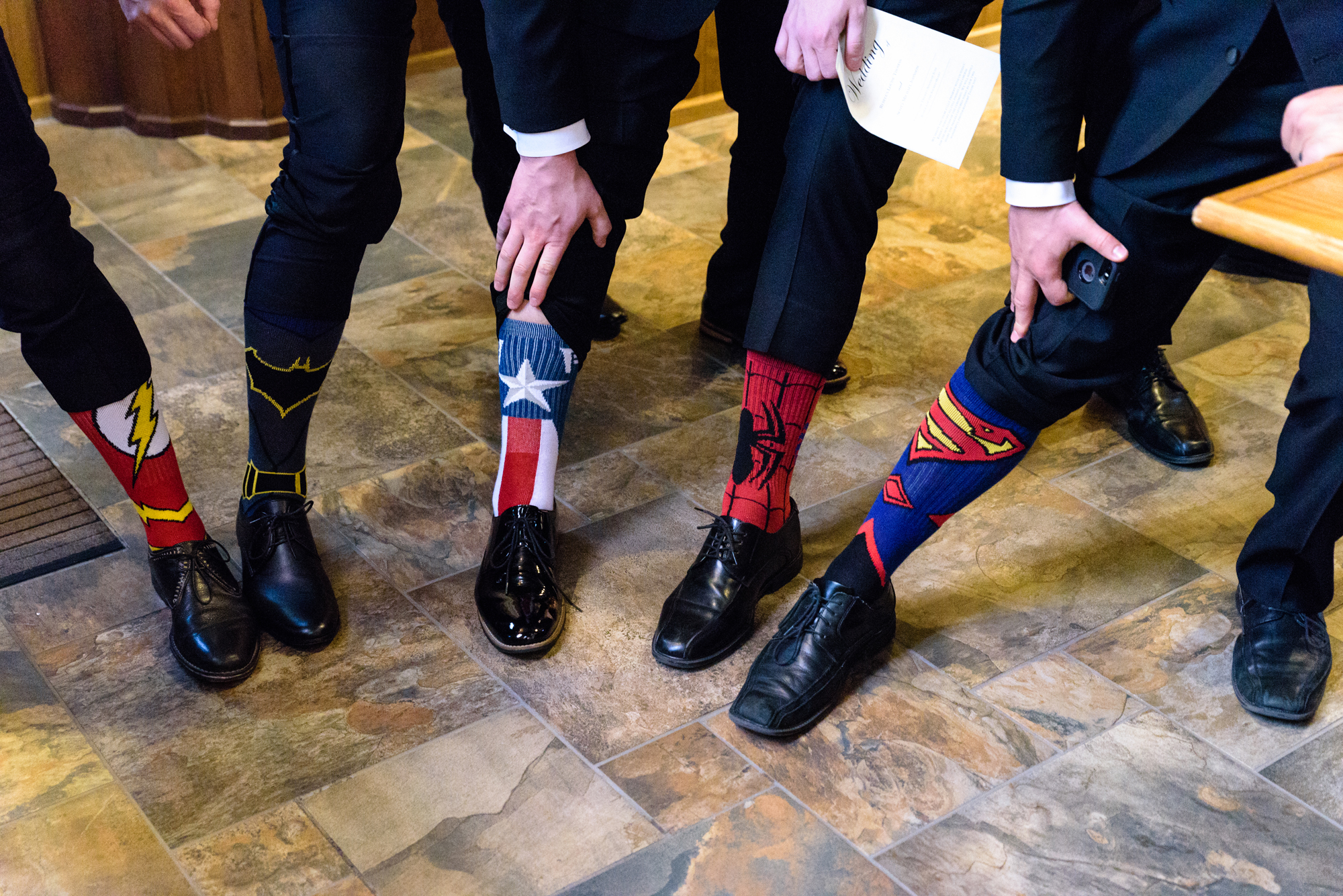 Groomsmen socks before a wedding ceremony at the Basilica of the Sacred Heart on the campus of the University of Notre Dame