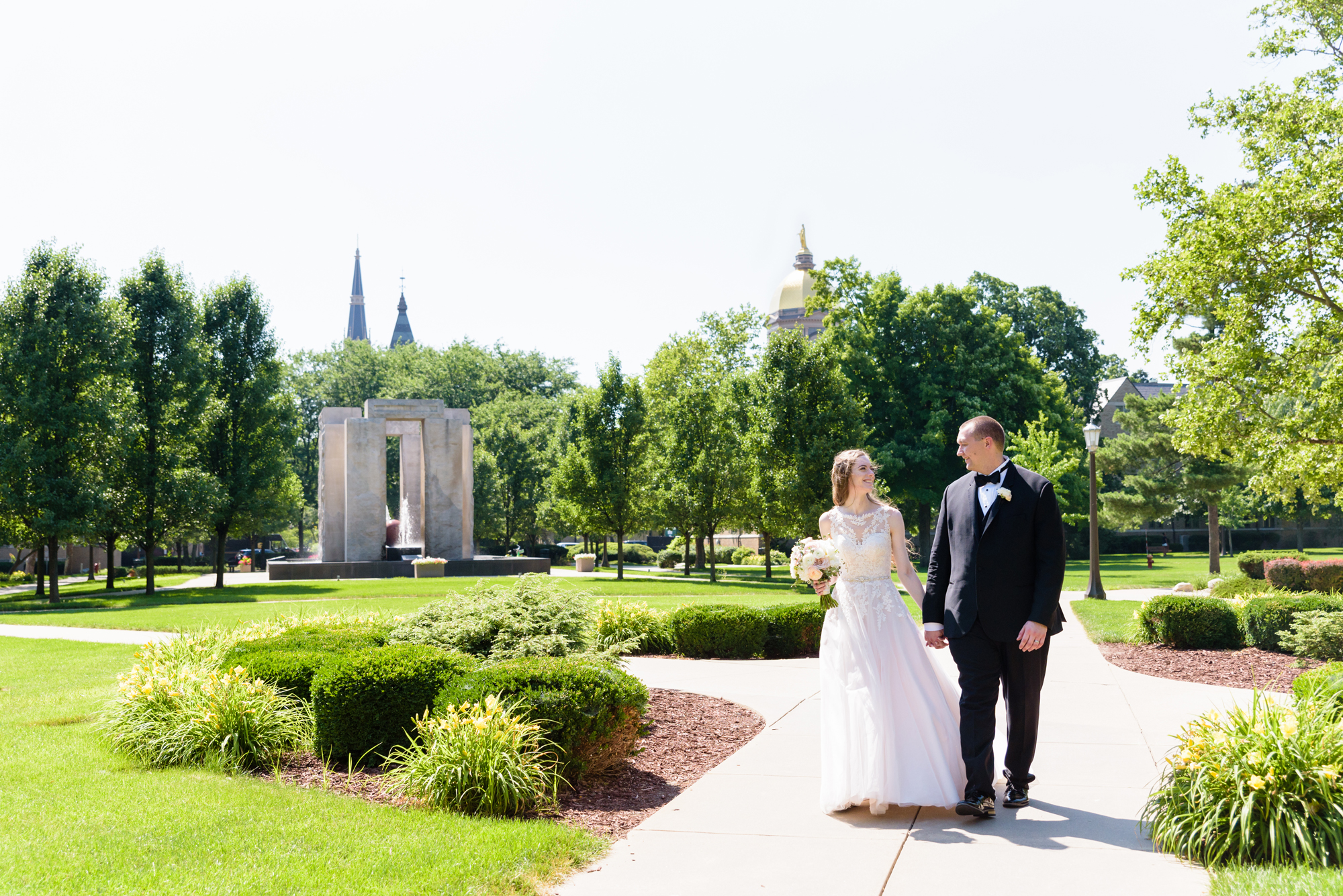 Bride & Groom by the Clarke memorial fountain after their wedding ceremony at the Basilica of the Sacred Heart on the campus of the University of Notre Dame