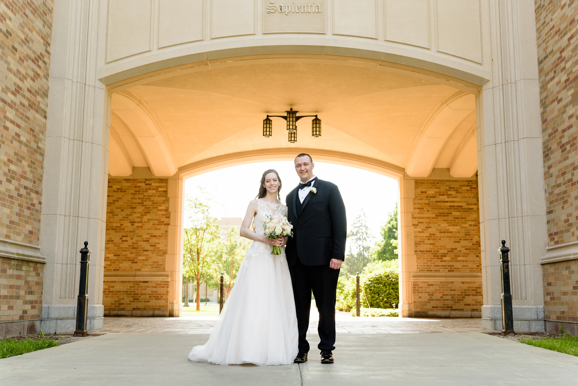 Bride & Groom under the law library after their wedding ceremony at the Basilica of the Sacred Heart on the campus of the University of Notre Dame