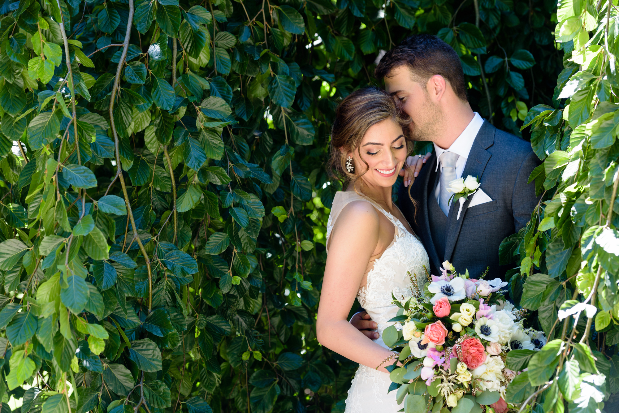 Bride & Groom in front of an exotic California inspired tree after their wedding ceremony at the Basilica of the Sacred Heart on the campus of the University of Notre Dame