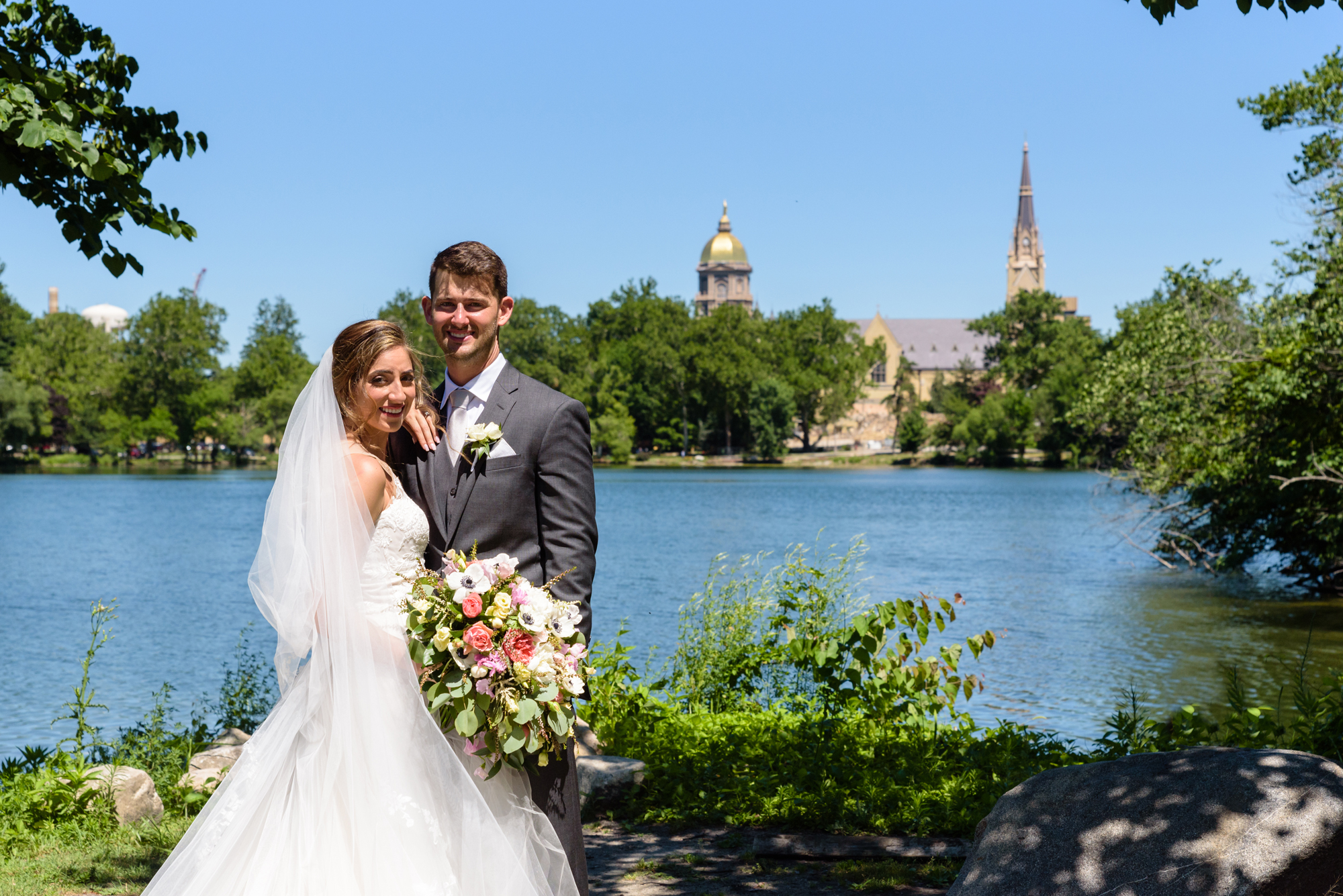 Bride & Groom with the Golden Dome, Basilica & St Mary's Lake after a wedding ceremony at the Basilica of the Sacred Heart on the campus of the University of Notre Dame