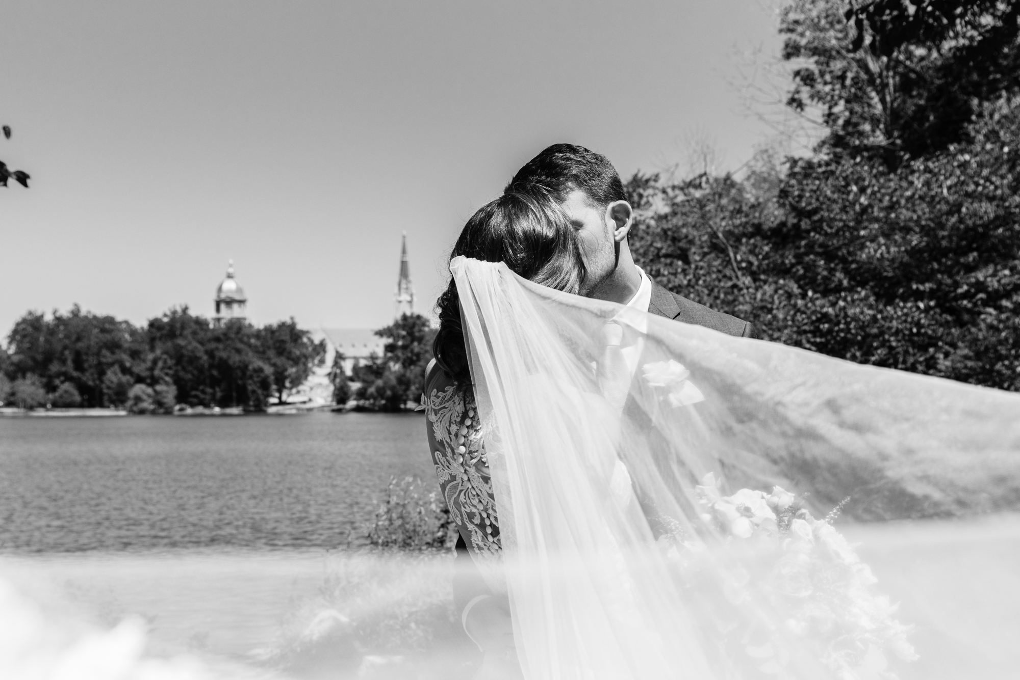 Bride & Groom with the Golden Dome, Basilica & St Mary's Lake after a wedding ceremony at the Basilica of the Sacred Heart on the campus of the University of Notre Dame