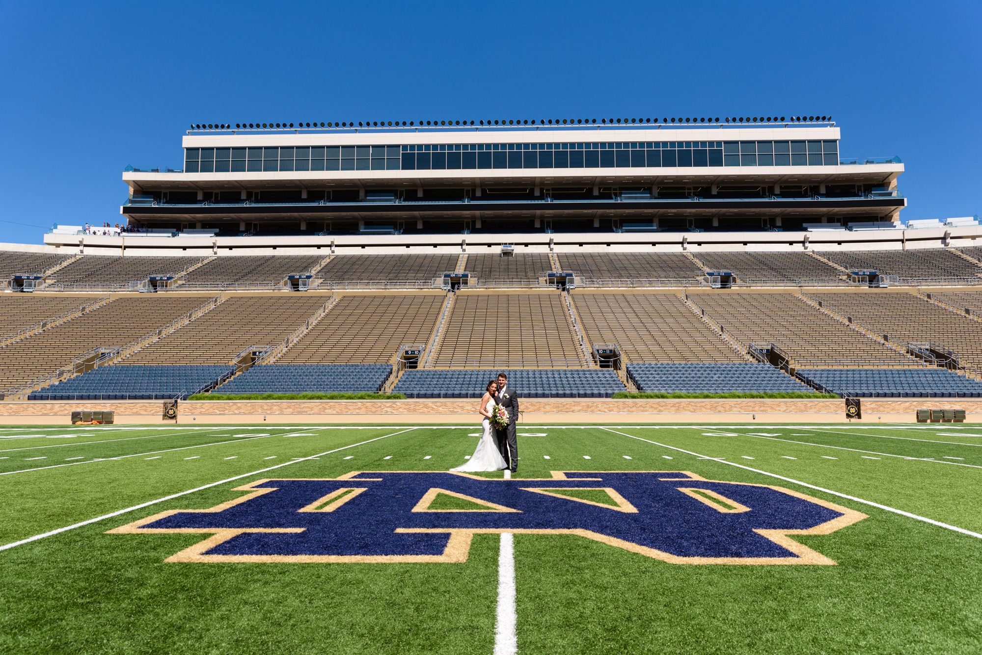 Bride & Groom in the Football Stadium after their wedding ceremony at the Basilica of the Sacred Heart on the campus of the University of Notre Dame