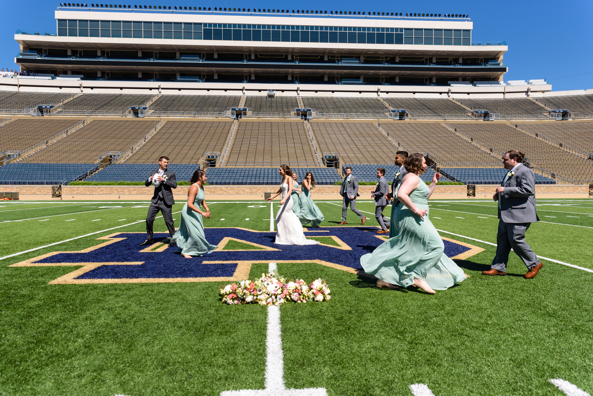 Bridal Party in the Football Stadium after their wedding ceremony at the Basilica of the Sacred Heart on the campus of the University of Notre Dame