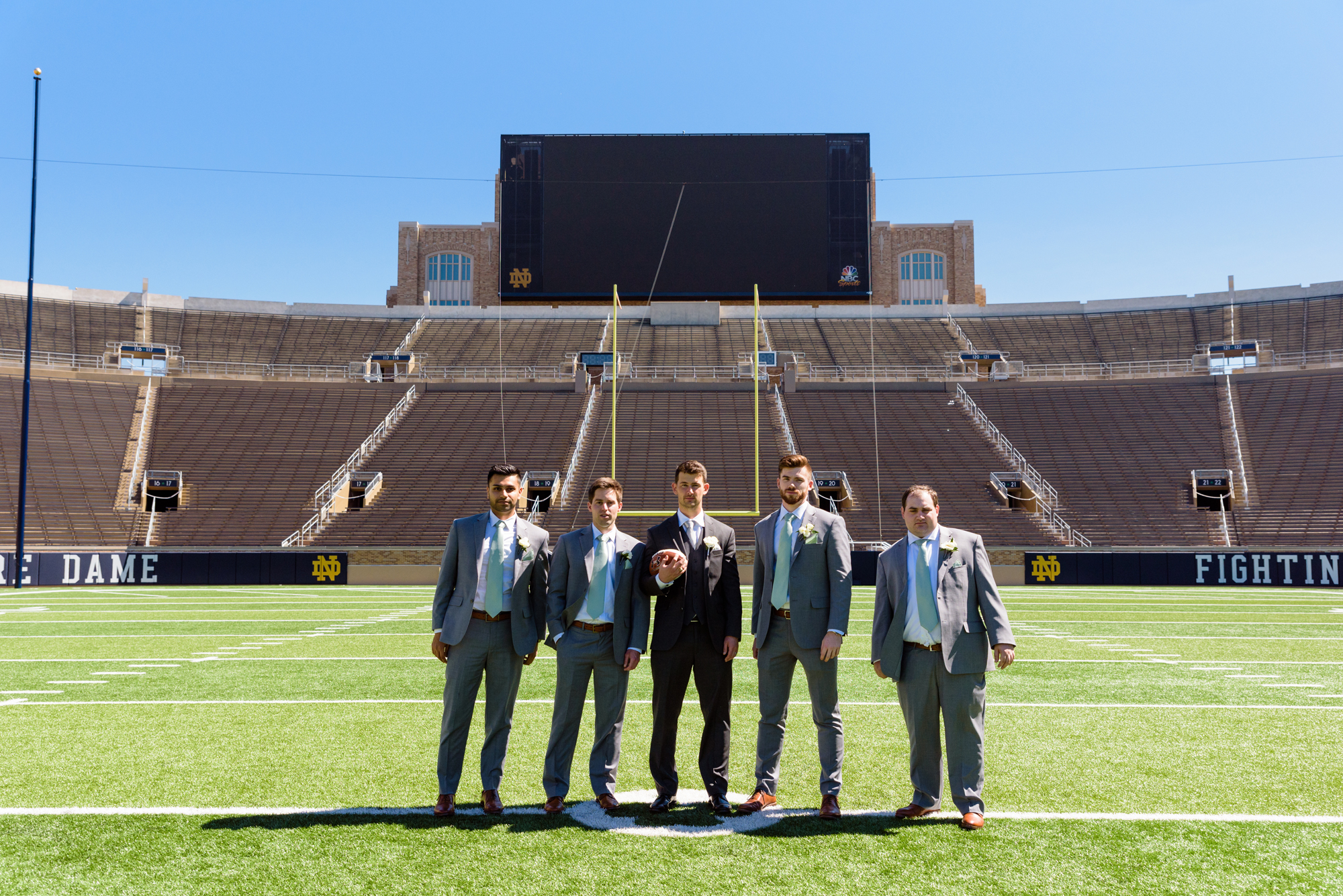 Groomsmen in the Football Stadium after their wedding ceremony at the Basilica of the Sacred Heart on the campus of the University of Notre Dame