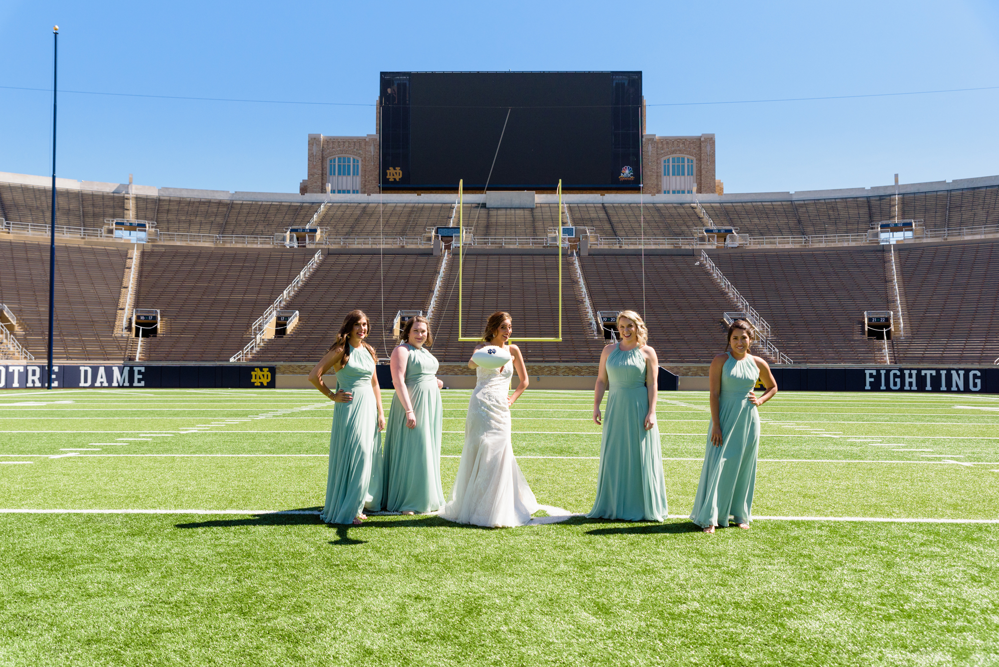 Bridesmaid in the Football Stadium after their wedding ceremony at the Basilica of the Sacred Heart on the campus of the University of Notre Dame