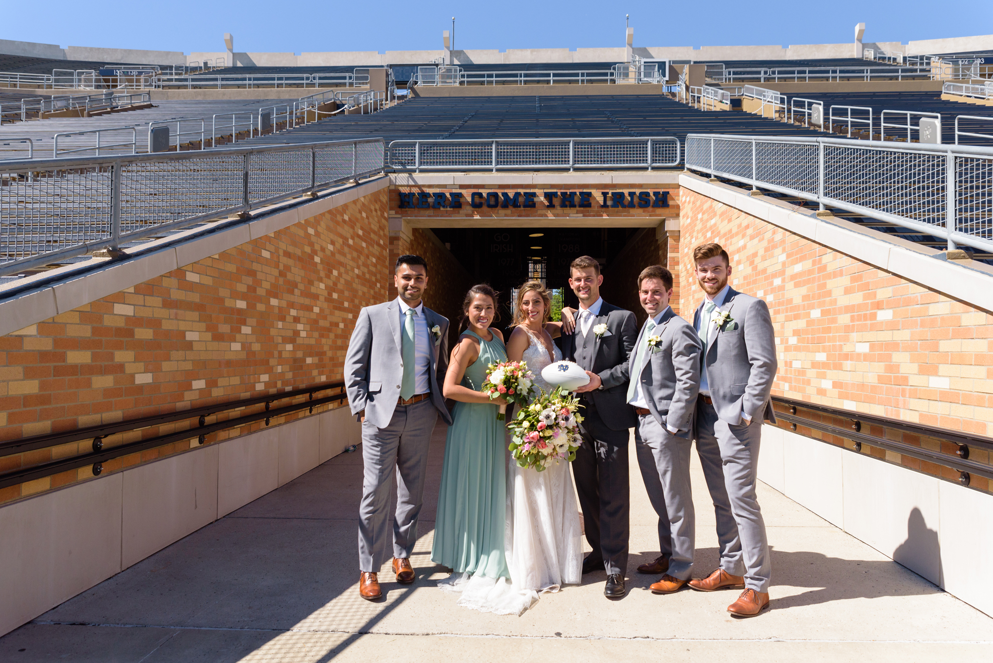 Bridal Party in the Football Stadium after their wedding ceremony at the Basilica of the Sacred Heart on the campus of the University of Notre Dame