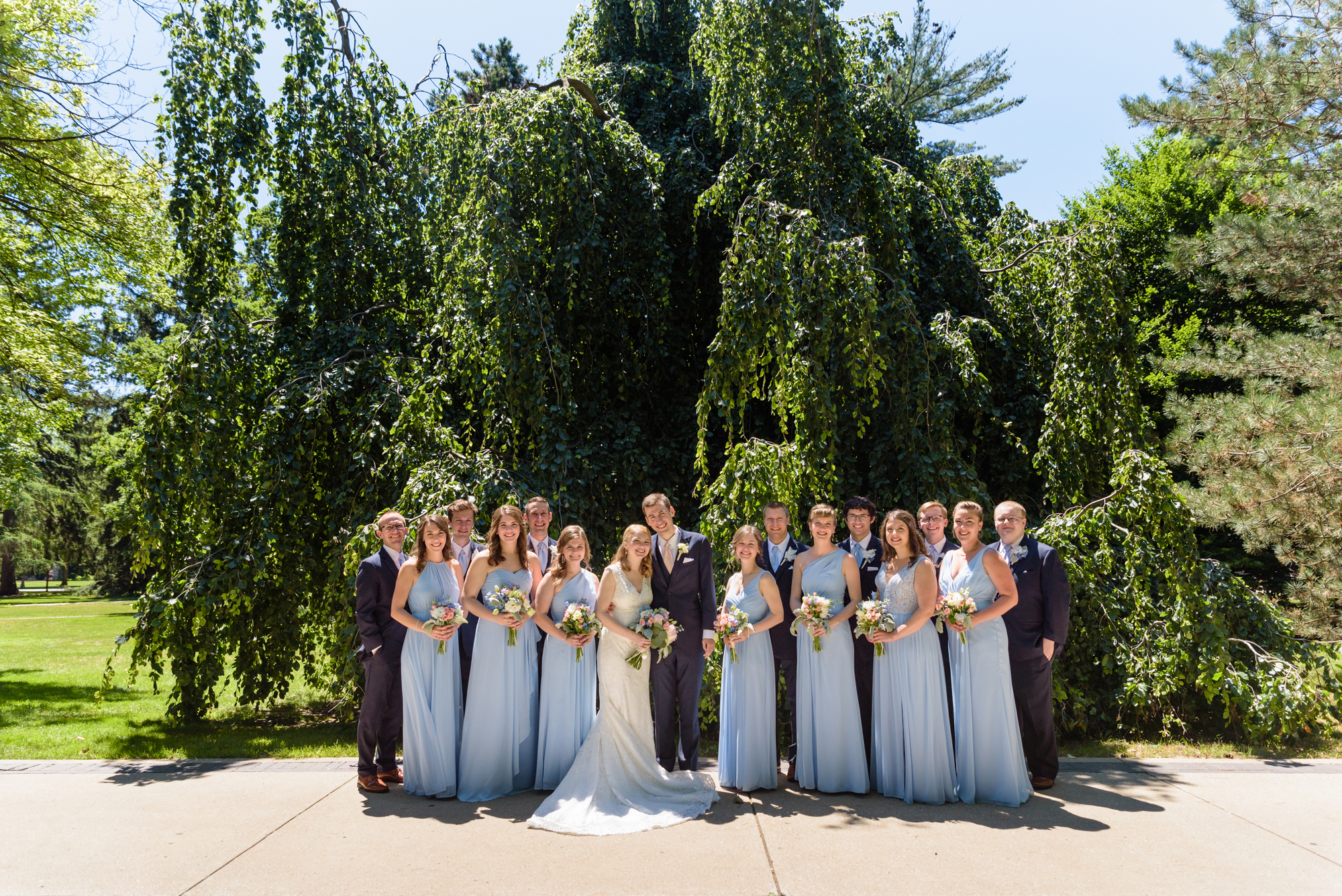 Bridal Party in front of an exotic California inspired tree after a wedding ceremony at the Basilica of the Sacred Heart on the campus of the University of Notre Dame